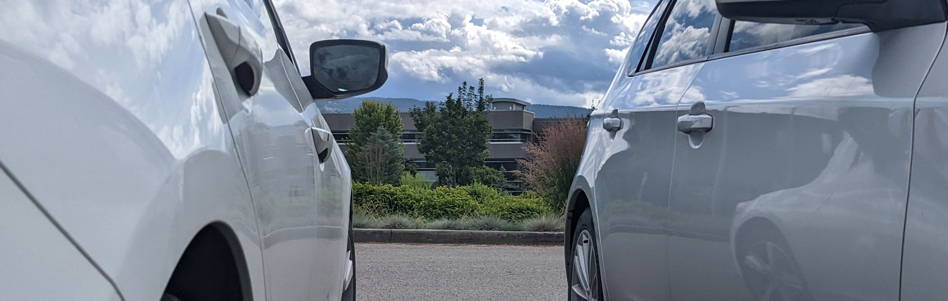 Two parked cars with FIPKE building in the background